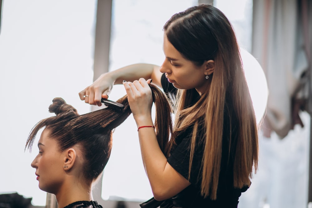 woman brushing out her clients' hair