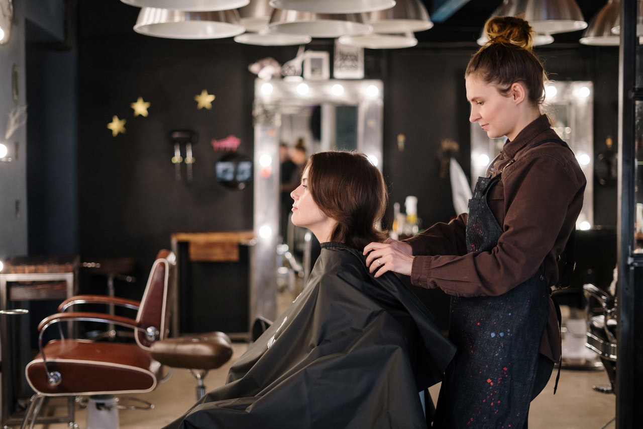Woman getting a haircut in a salon.