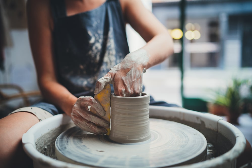 woman doing at a pottery wheel