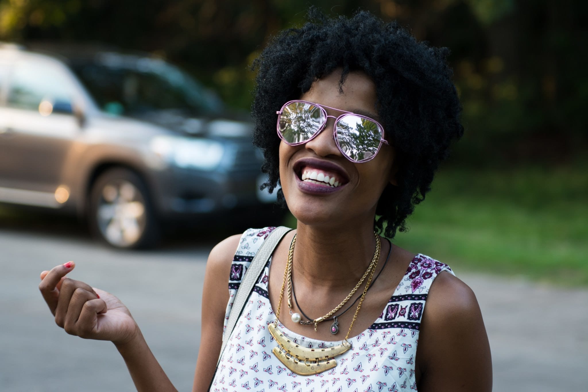 woman smiling with sunglasses on